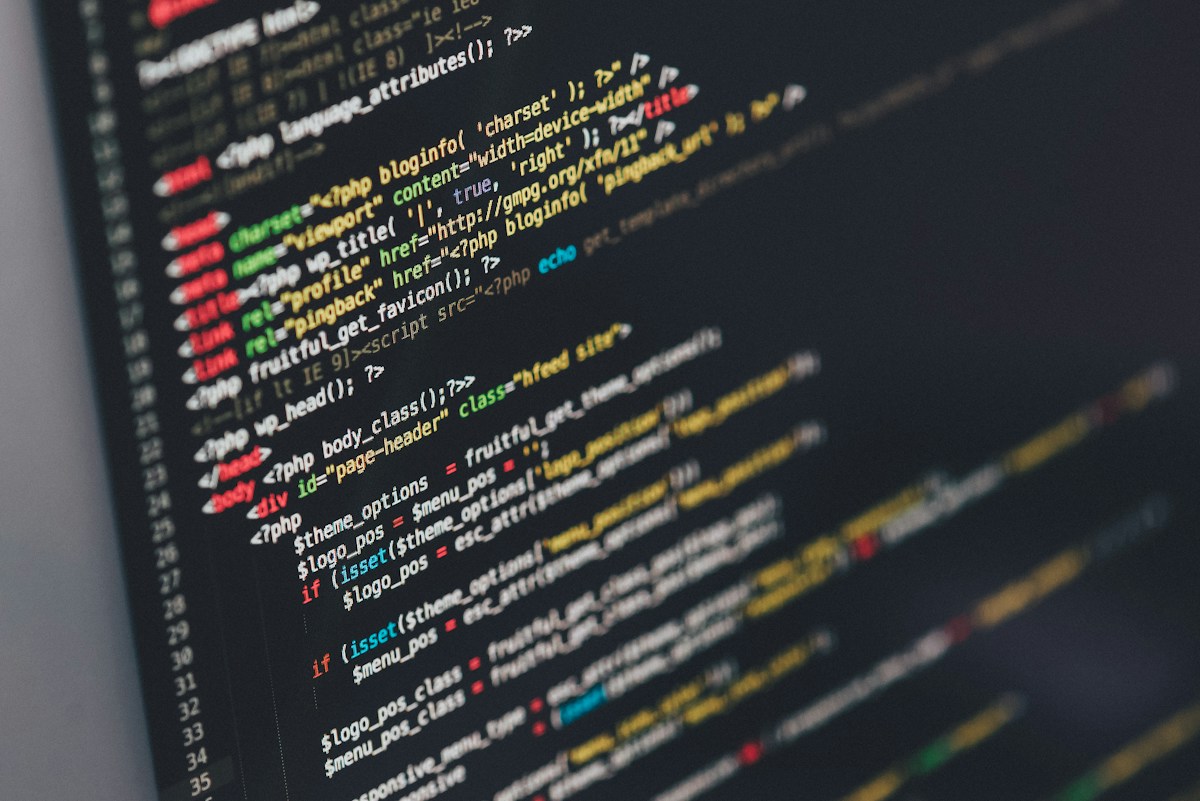 Code on a desktop monitor during technical performance optimization