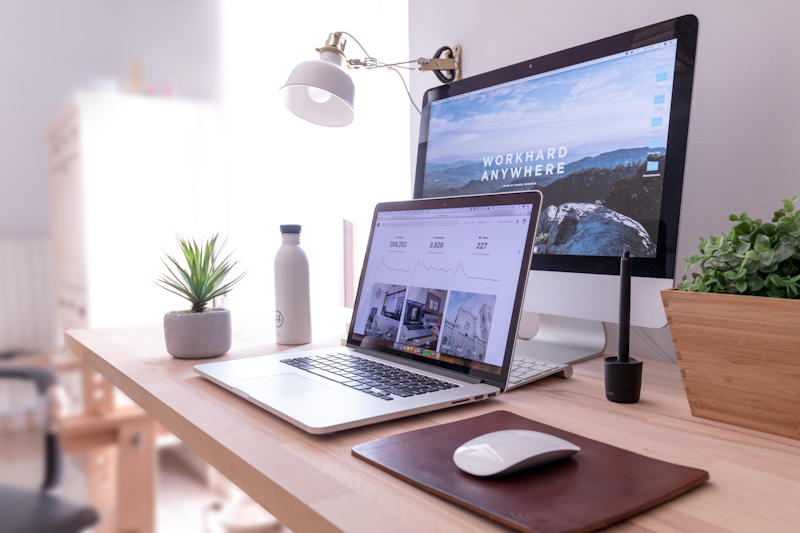 Desktop computer and organized workspace for front-end design and digital reporting